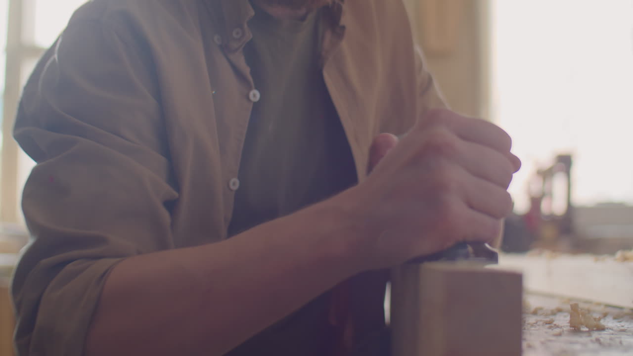 Carpenter Using Hand Plane and Double Square while Woodworking