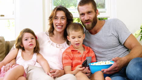 family with pop-corn on a couch