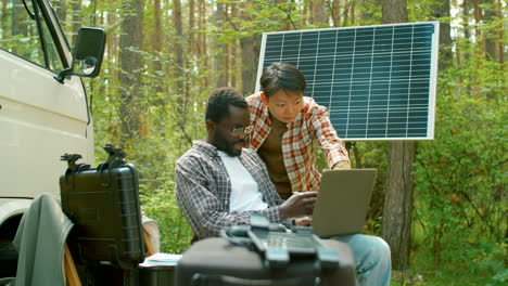 scientists looking at laptop screen