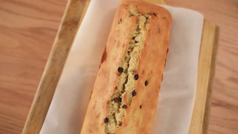 top view of freshly baked chocolate chip loaf, spin on wooden background