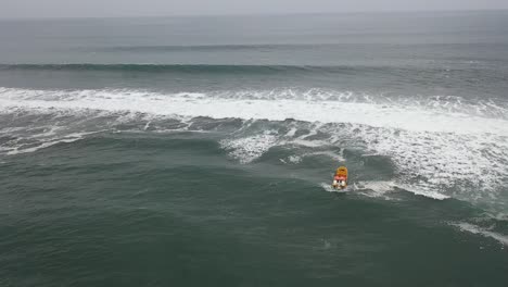 fishing-boat-going-fishing-on-a-day-of-swells-on-the-coast-of-chile-bucalemu-recording-of-a-drone