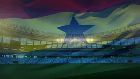 bandera ondeando frente a un estadio