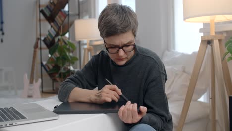 woman working on graphics tablet at home