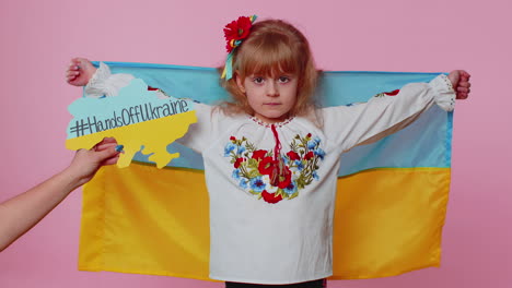 upset toddler ukrainian girl kid in embroidery dress protesting war conflict raises national flag