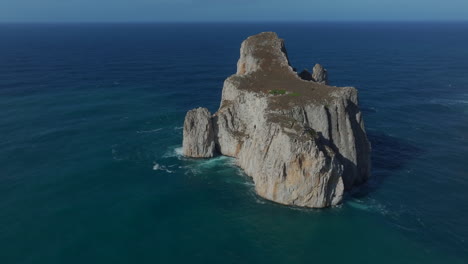 aerial view with zoom out to pan di zucchero on the island of sardinia, near masua