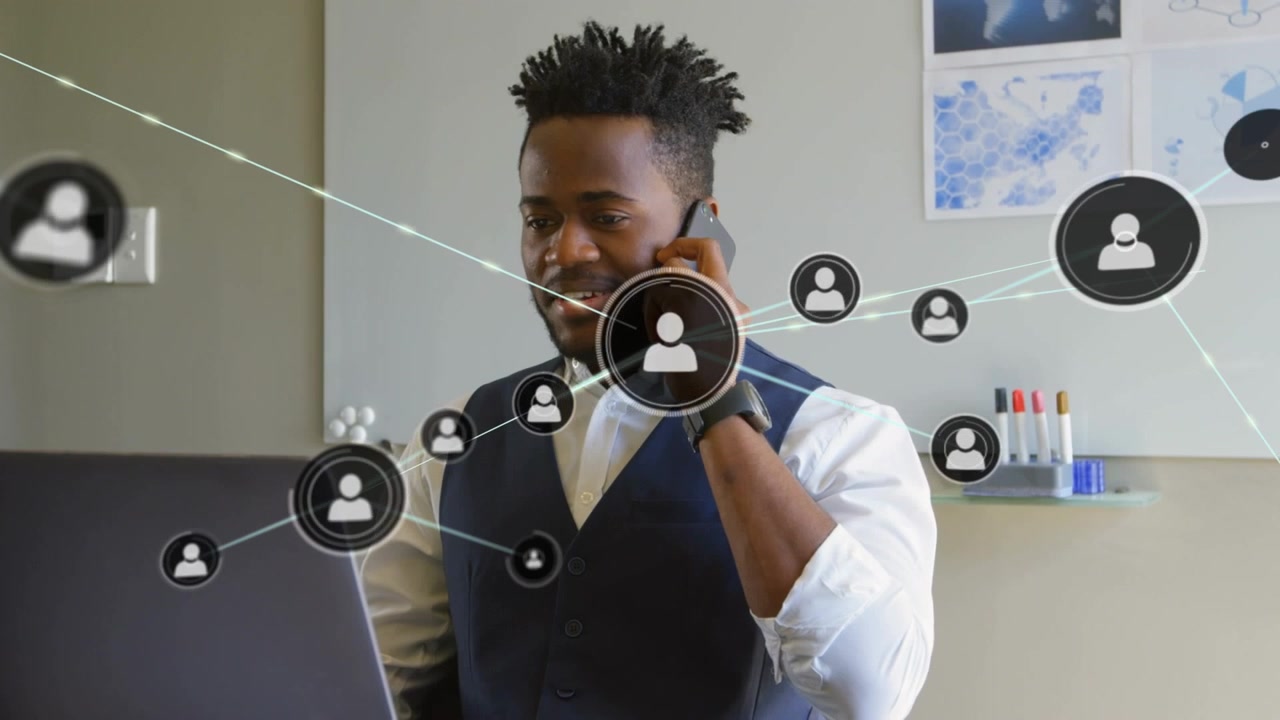 Profile icons connecting with lines over african american man talking on cellphone in office