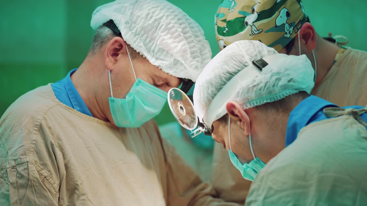 In surgery. Medical team performing operation in hospital operating theater. Working with surgical instruments.