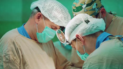 in surgery. medical team performing operation in hospital operating theater. working with surgical instruments.