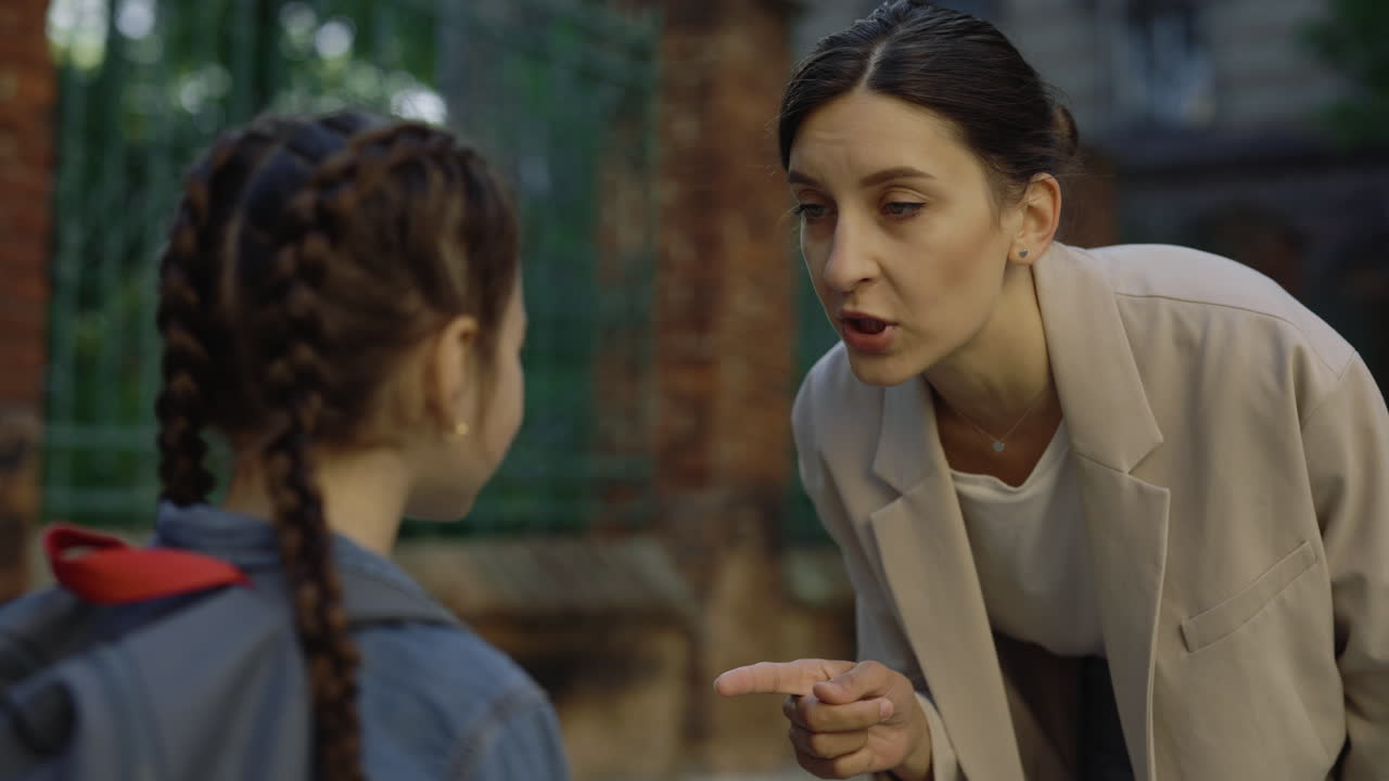 Mother and Daughter Arguing Outside School