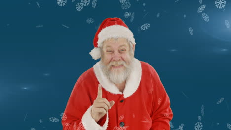 animación de santa claus sonriendo sobre el paisaje de invierno con nieve cayendo sobre un fondo azul