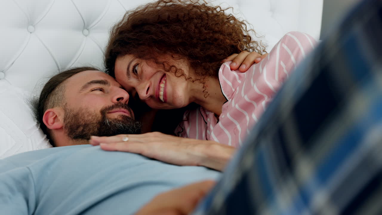 Love, couple and kiss in bed with a man