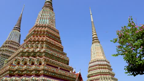 colorful stupas and statues at wat pho temple in bangkok, thailand