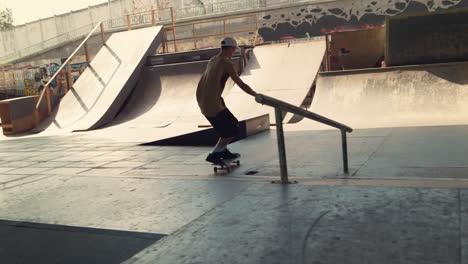 hipster man enjoying extreme sport with skateboard in urban skate park.