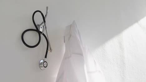 laboratory coat and stethoscope hanging on hook 4k