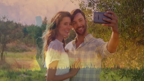 woman and man taking selfie in olive grove, showing marketing analytics with animated data graphs