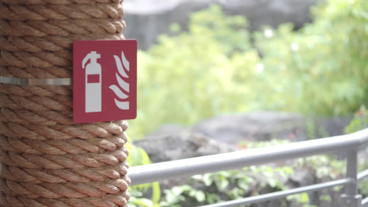 Fire Extinguisher Sign on Rope-Wrapped Post