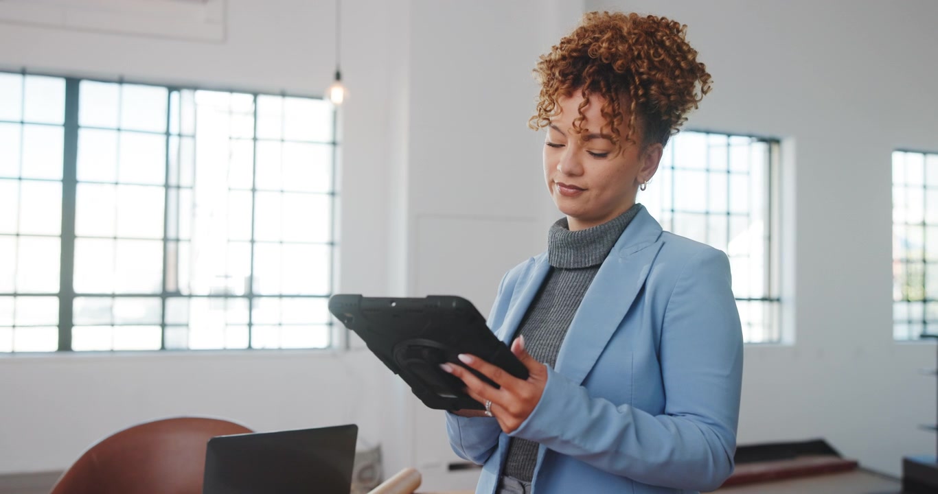 Professional Woman Using Tablet in Modern Office