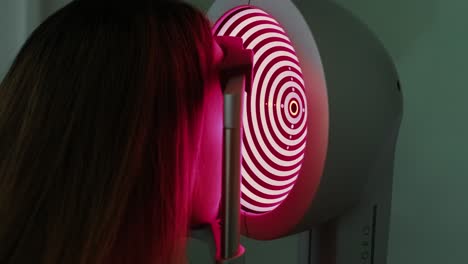 corneal topography. eye exam with corneal analyzer for beautiful woman