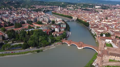 drone aerial view over verona city, ponte scaligero and adige river, italy