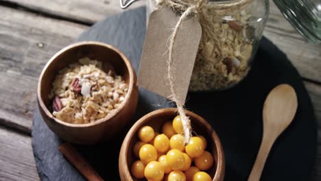 bowl of cape gooseberry and jar of muesli on a table 4k