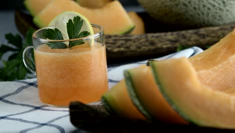 whole and sliced of japanese melons,honey melon or cantaloupe (cucumis melo) glass of melon smoothie healthcare concept.