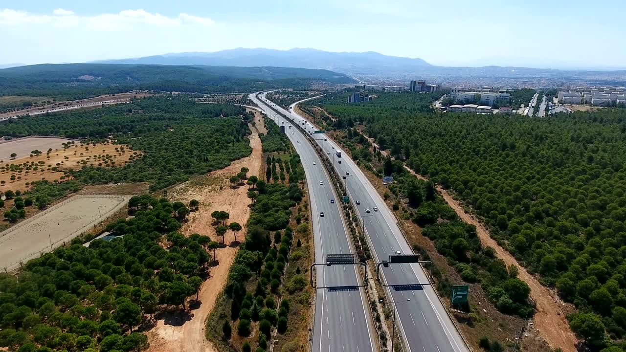 활기찬 초록색 과 초원을 가로질러 흐르는 바쁜 고속도로 교차로 위에서 공중 촬영