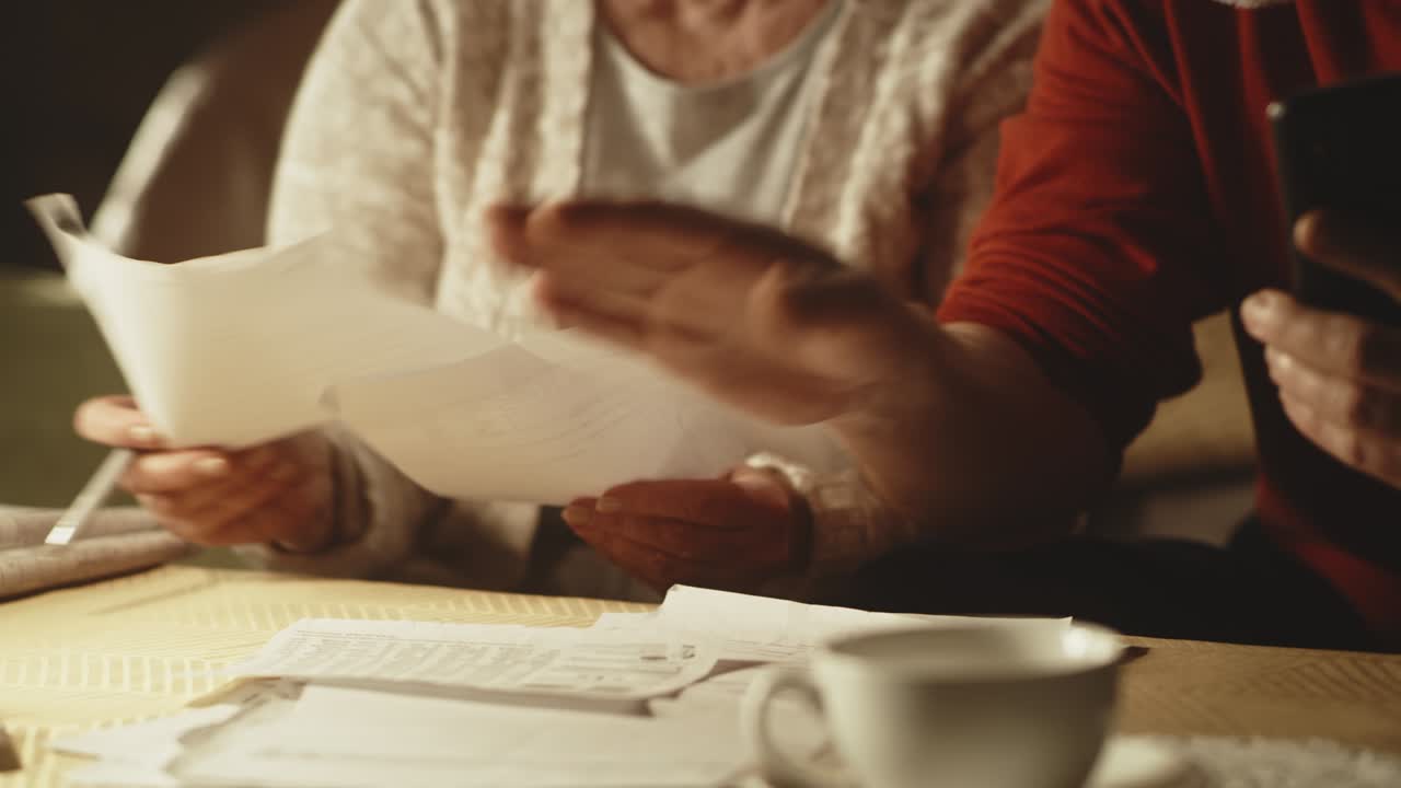 Aged couple discussing utility bills