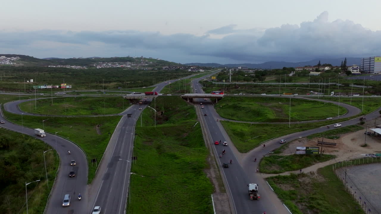 Aerial of the BR 104 and BR 232 highway interchange or trevo rodoviario in Caruaru Pernambuco Northeast Brazil with city traffic cars during rush hour.
