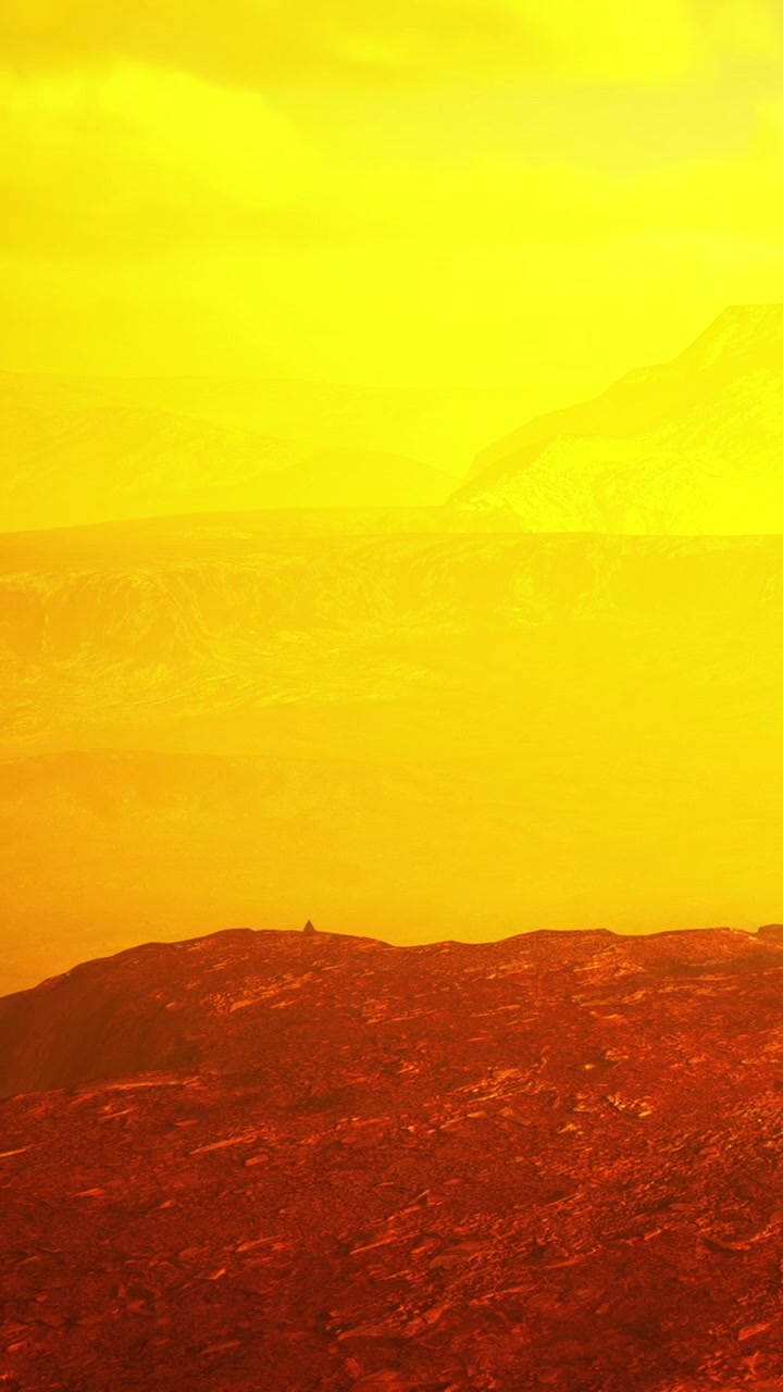Landscape of yellow hues with distant mountains and ground details in focus