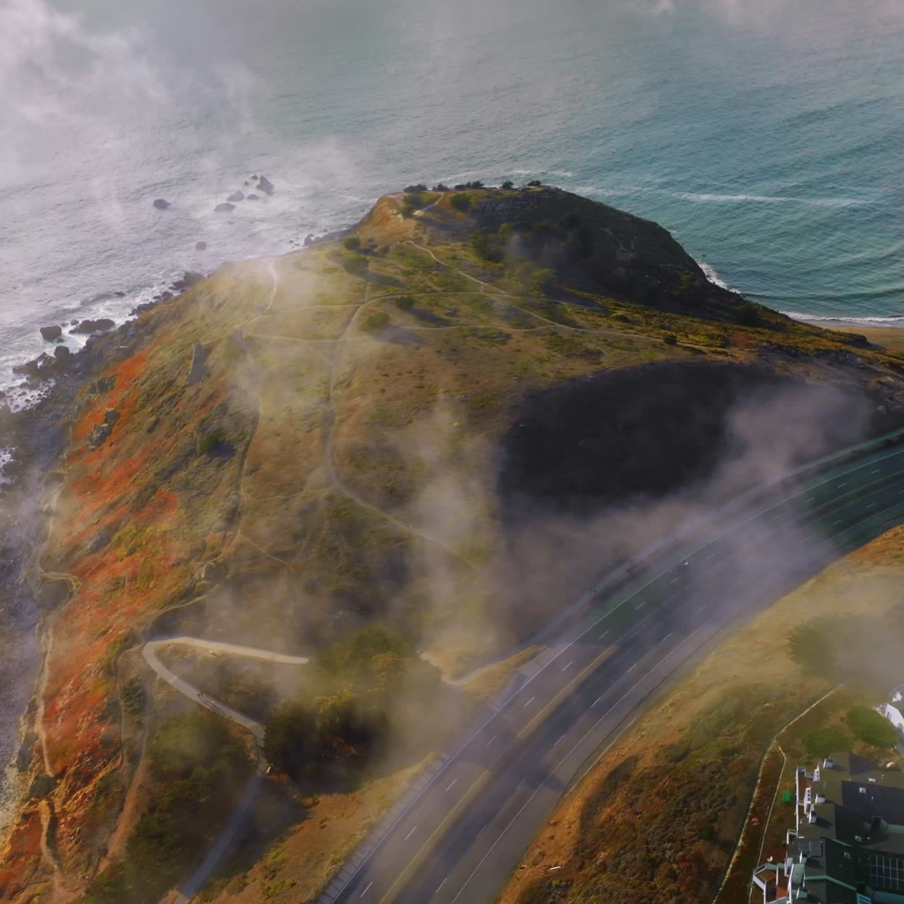 Road passing through the rocks of Montara, California, USA. Drone descending over the hill on the State Beach of Montara