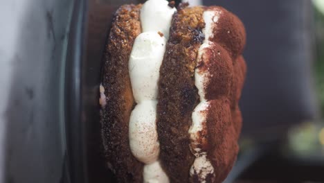 close-up of a cake with cream and cocoa powder