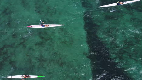 overhead shot of a surf ski race competitor on the blue water