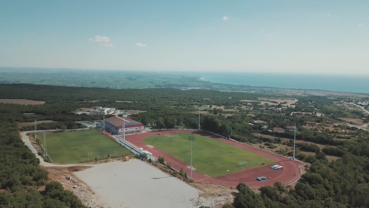 Aerial view of a sports field near the sea