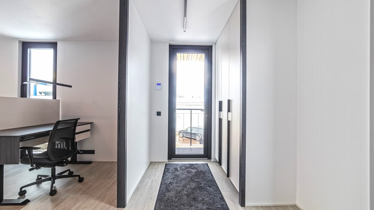 Minimalist modern home office showcasing a stylish desk setup with natural light and contemporary design on bright sunny day, orbit left