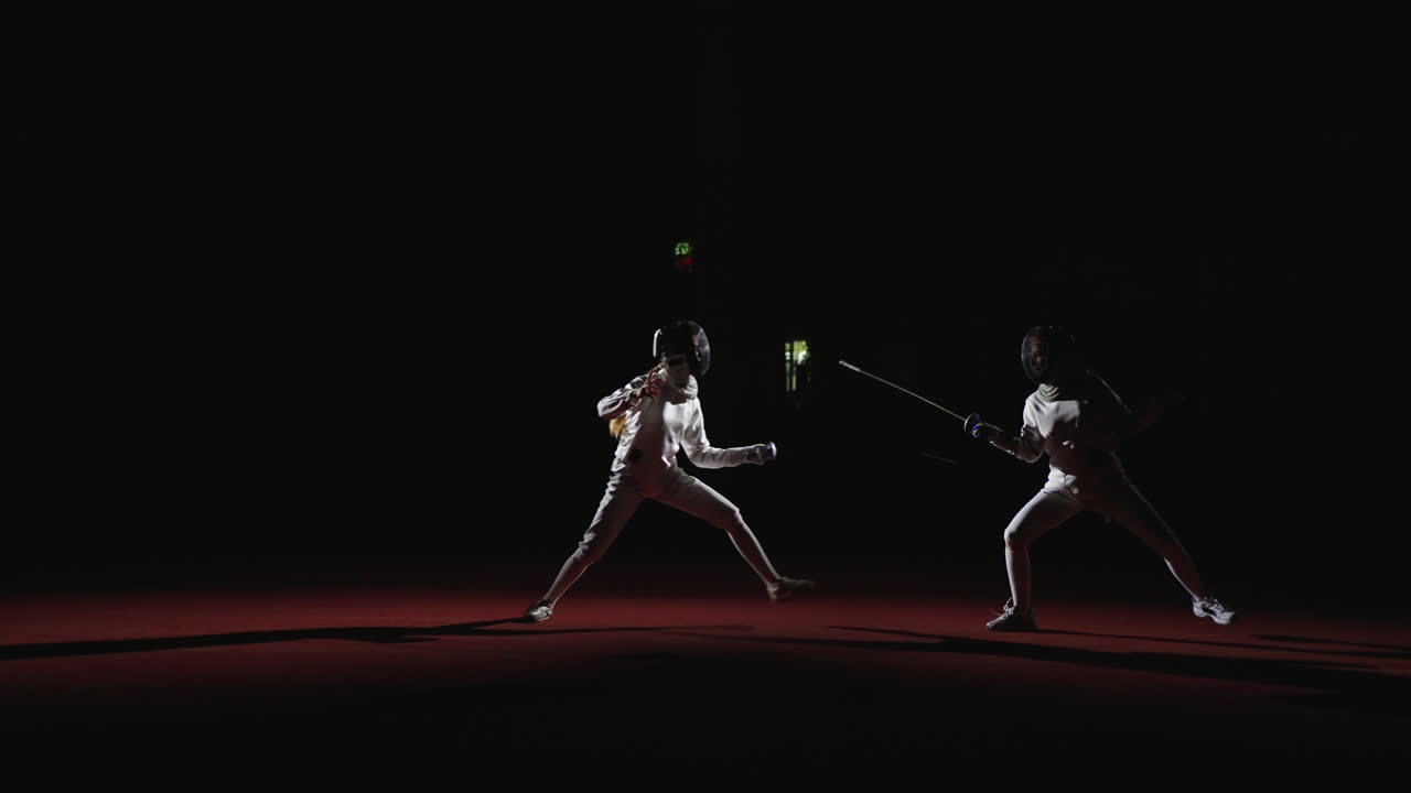 Two fencers compete in a match.