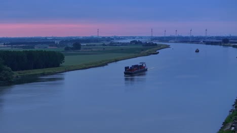 a floating ship with a cargo of containers on a calm river