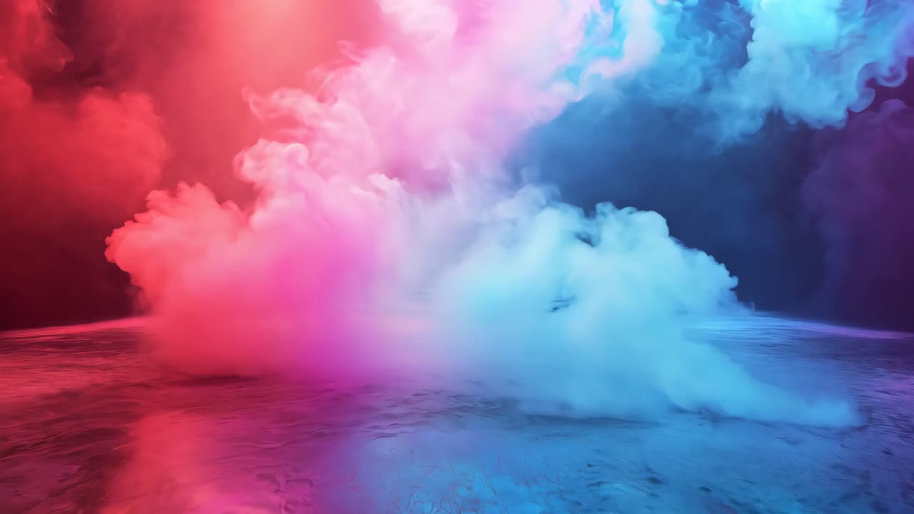 A large, empty stage with a colorful light show featuring red, blue, and purple lights. The stage is empty and the lights are on, creating a vibrant and dynamic atmosphere