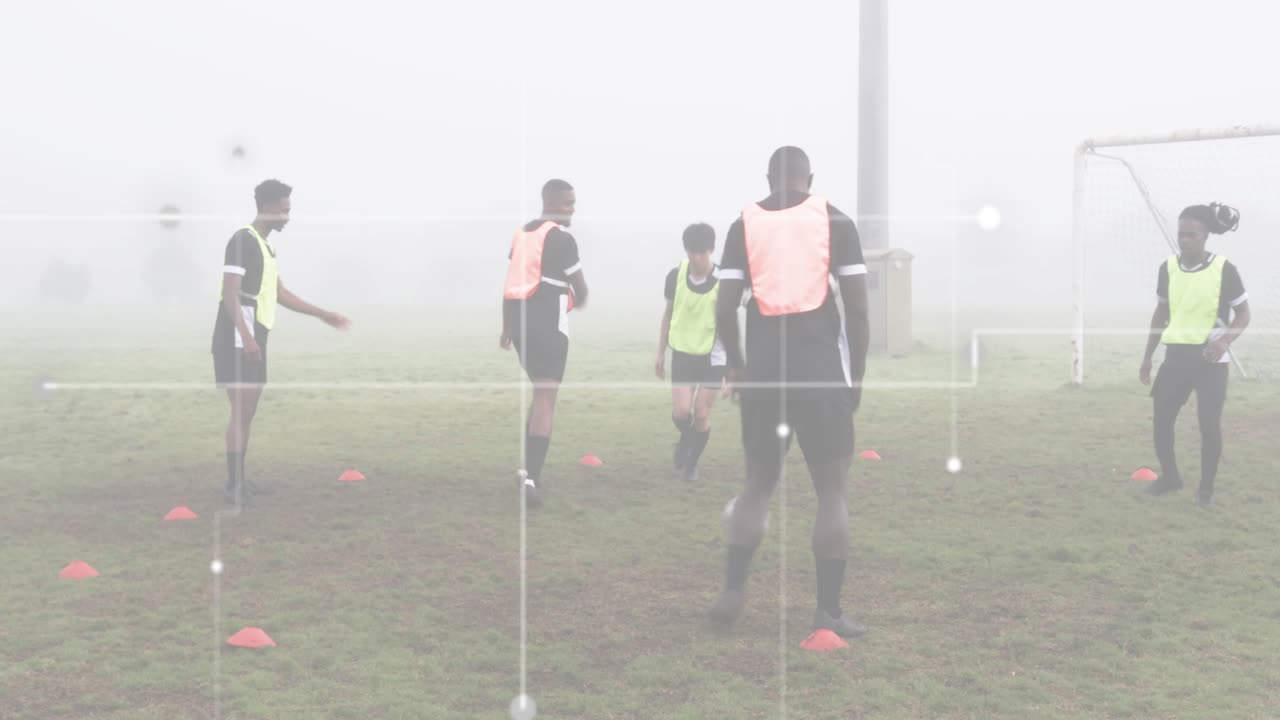 Five male players executing rondo training in field, responding to initial pass through cone grid