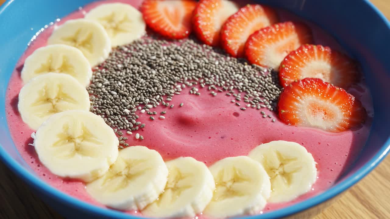 Vibrant Berry Smoothie Bowl Topped with Fresh Strawberries, Bananas, and Chia Seeds for a Healthy and Delicious Breakfast Choice