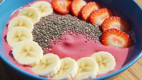 vibrant berry smoothie bowl topped with fresh strawberries, bananas, and chia seeds for a healthy and delicious breakfast choice