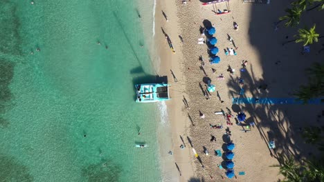 Vogelperspektive:-Aufnahme-Eines-überfüllten-Und-Wunderschönen,-Klaren,-Grünen-Strandes-Im-Mittelmeer,-Während-Sowohl-Einheimische-Als-Auch-Touristen-Das-Wochenende-Am-Strand-Genießen