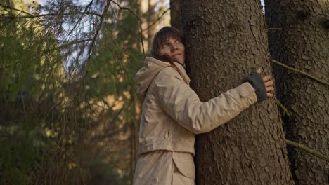 woman hugging a tree in a forest