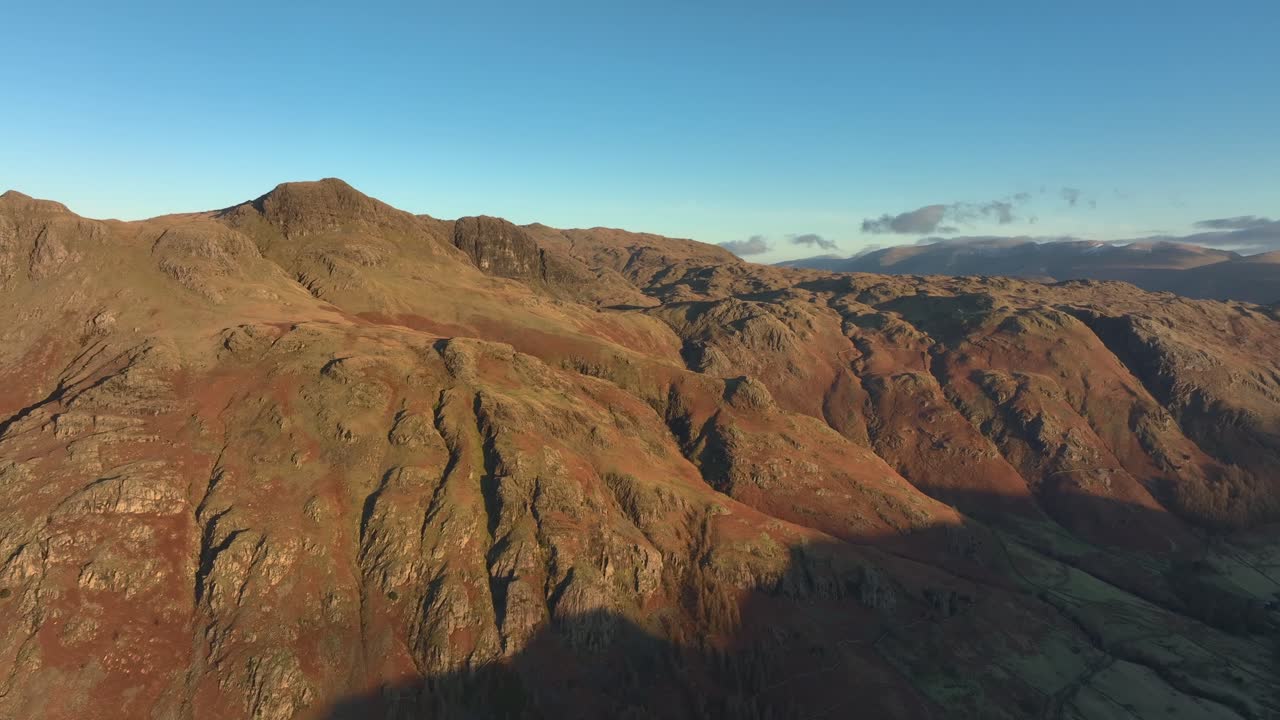 Mountains and crags bathed in early morning wintry dawn light. Langdales, English Lake District, Cumbria, UK.