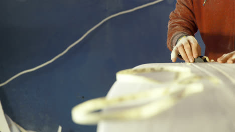 man making surfboard 4k