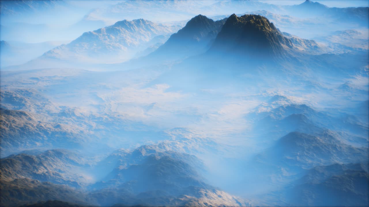 Distant mountain range and thin layer of fog on the valleys