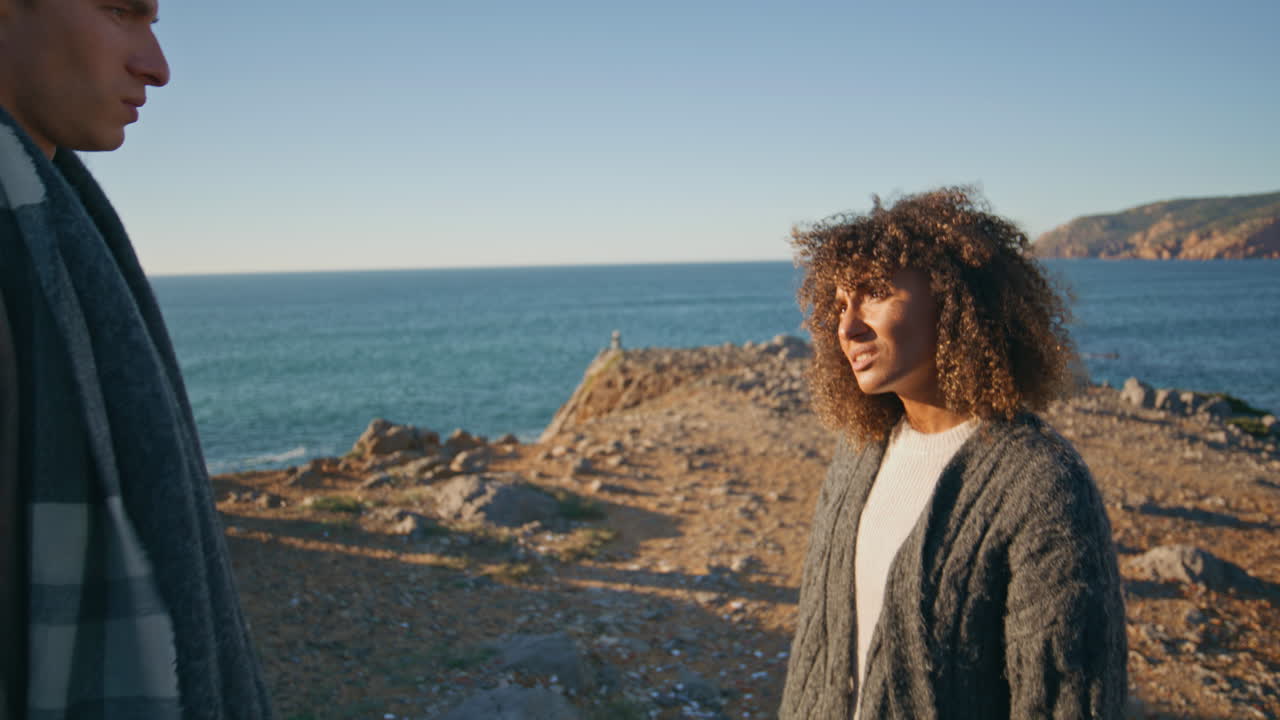 Young couple scandaling ocean vacation closeup. Family feeling disappointment