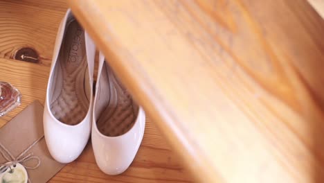 wedding shoes and accessories on wooden floor