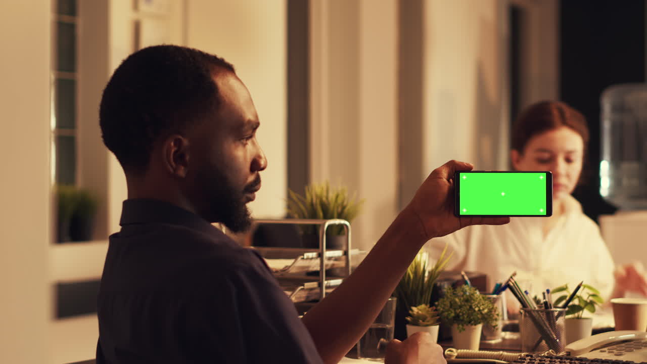 African american man using smartphone with greenscreen