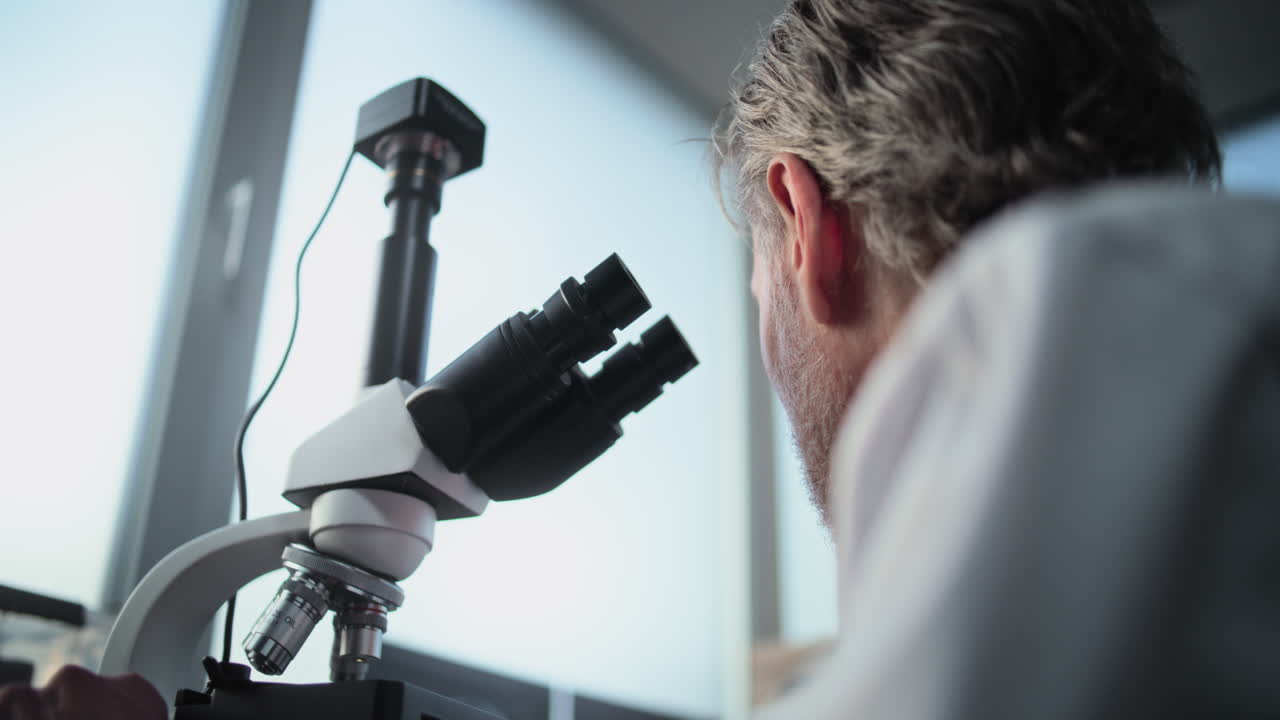 Scientist using microscope in a lab