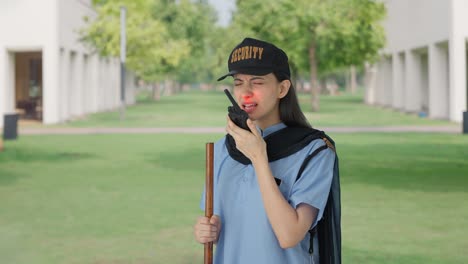 indian female security guard talking through walkie talkie